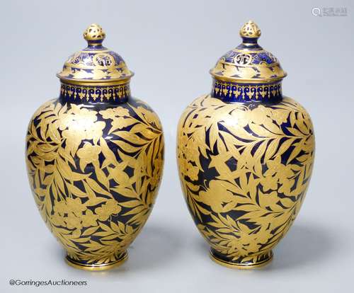 A pair of Crown Derby blue and gilt vases, both with restore...