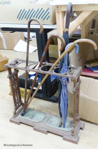 A Victorian cast iron stickstand and five sticks/umbrellas, ...