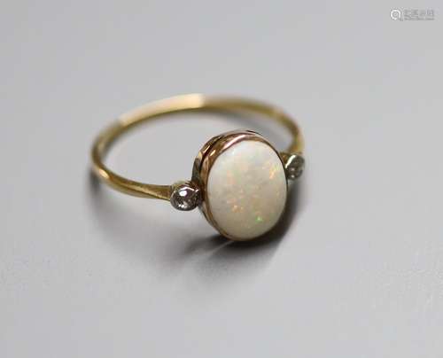 An 18ct, white opal and two stone diamond set oval ring, siz...