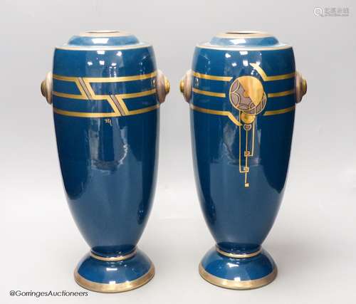 A pair of Art Deco blue glazed pottery vases, initialled PH,...