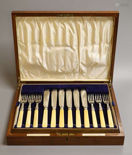 A cased set of twelve pairs of George V ivory handled silver...