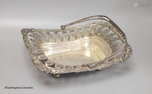 A George III silver swing-handled cake basket with cast and ...