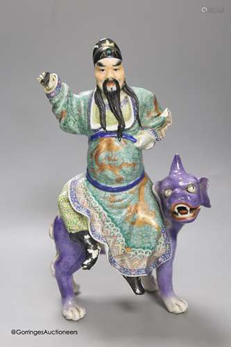 A Chinese enamelled porcelain figure group of an immortal on...