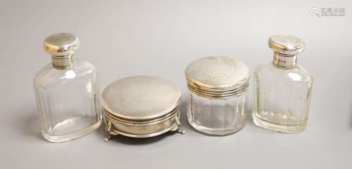 Three silver mounted glass toilet bottles and a George V sil...