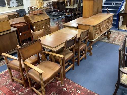 A Maple & Co oak dining suite of Italianate design, with car...