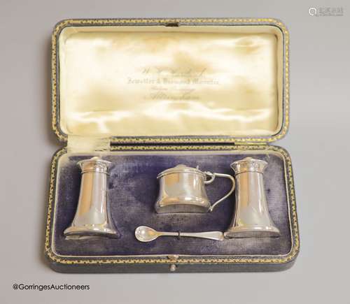 A cased George V silver three piece condiment set, with sing...