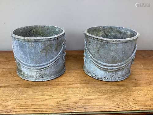 A pair of circular lead garden planters, 23cm diameter, heig...