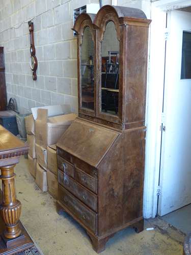 A Queen Anne style walnut double domed top bureau bookcase, ...