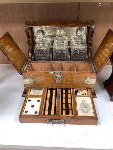 A Victorian oak tantalus and games compendium, height 33cm d...