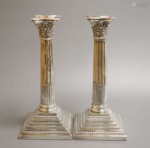 A pair of Edwardian silver Corinthian column candlesticks by...