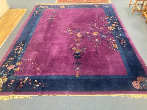 A large purple ground Chinese wool carpet, 342 x 276cm