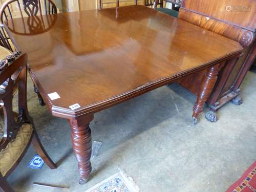 A late Victorian walnut extending dining table, (two spare l...