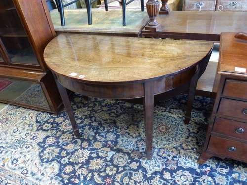 A George III mahogany demi lune drop flap dining table, leng...