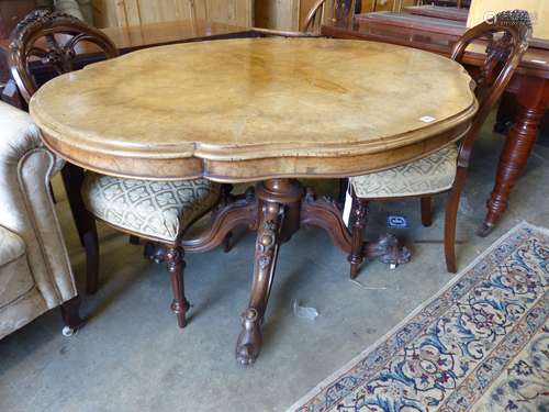 A Victorian figured walnut shaped oval tilt topped loo table...