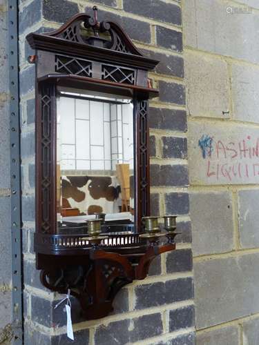 An Edwardian mahogany mirrored wall bracket with triple bras...