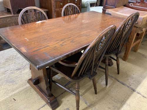 A 17th century style oak 'refectory' table on shaped trestle...