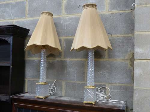 A pair of tall cut glass and gilt metal table lamps, having ...