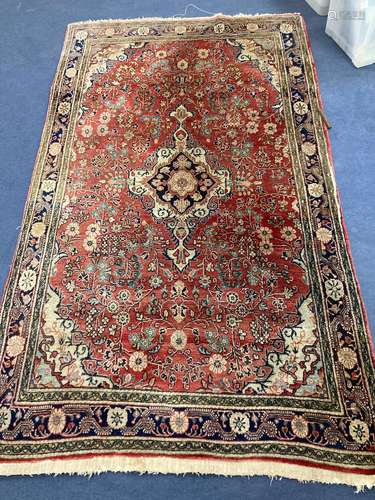 A red ground Persian rug, 210 x 135cm together with a smalle...