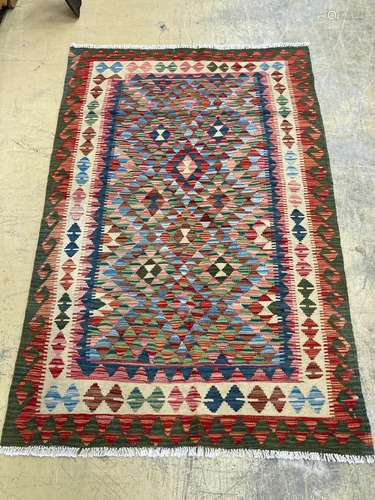 An Afghan multi-coloured geometric patterned kilim rug, 182 ...