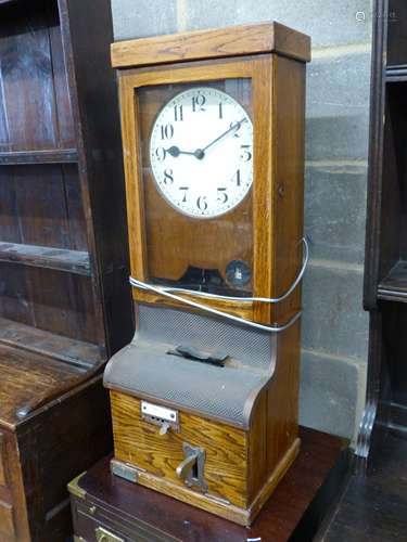 A vintage oak-cased electric wall factory time recorder cloc...