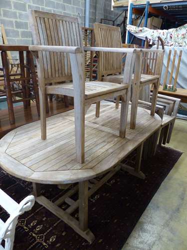 An oval weathered teak extending garden table, 240cm extende...