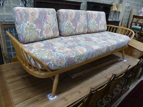 An Ercol light elm and beech settee 'surfboard' settee, leng...