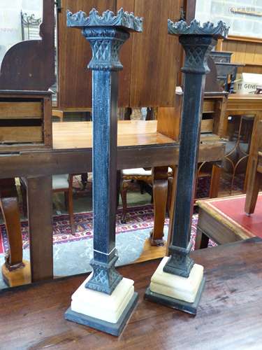 A pair of cast metal pricket candlesticks, height 67cm