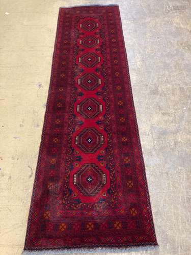 A Bokhara red ground runner, 290 x 82cm