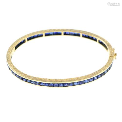 A sapphire hinged bangle, with diamond push-piece clasp.Diam...