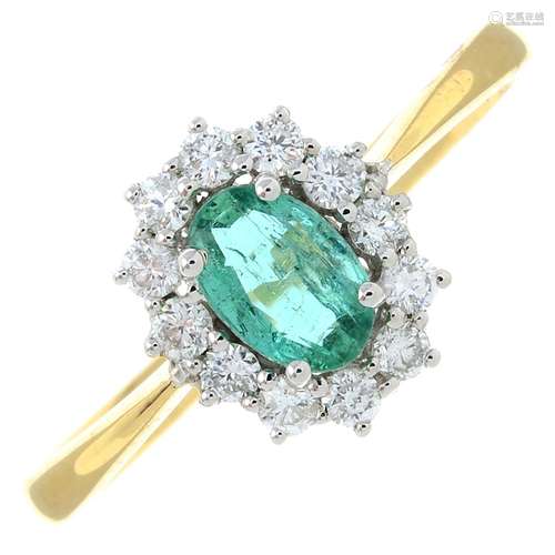 An 18ct gold emerald and diamond cluster ring.Emerald weight...