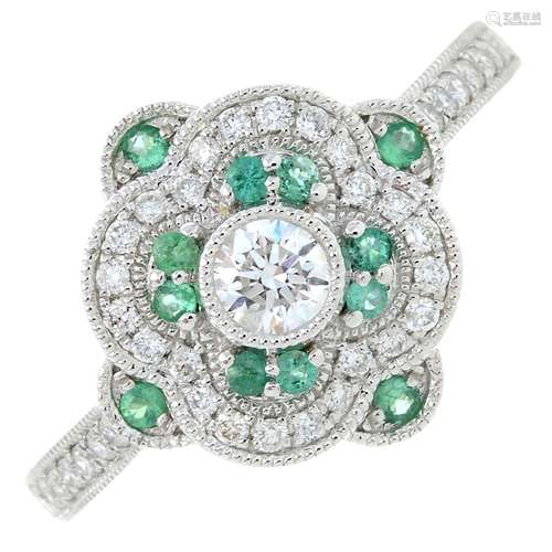 An 18ct gold diamond and emerald dress ring.Total emerald we...