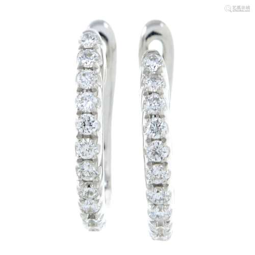 A pair of diamond earrings.Total diamond weight 0.16ct.