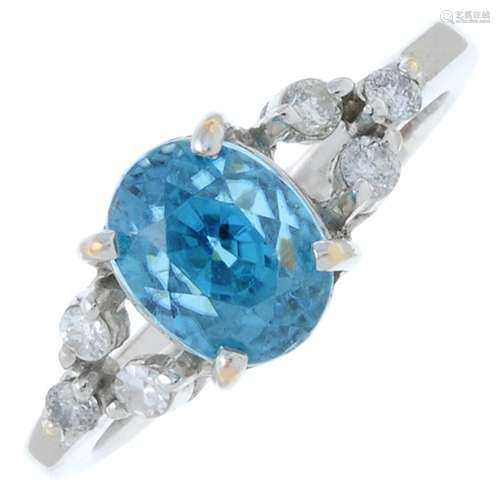 A blue zircon and brilliant-cut diamond dress ring.Estimated...