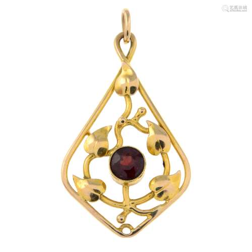An early 20th century gold garnet foliate pendant.Length 4.6...