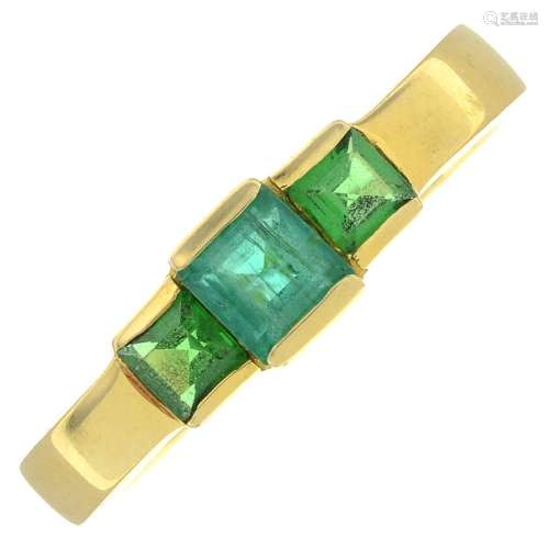 An emerald and green paste three-stone ring.Stamped 750.Ring...