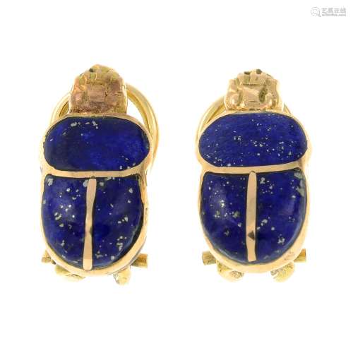 A pair of lapis lazuli earrings, each designed to depict a s...