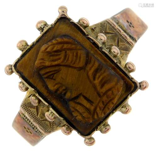 A late 19th century tiger's-eye cameo ring.Ring size L1/2.