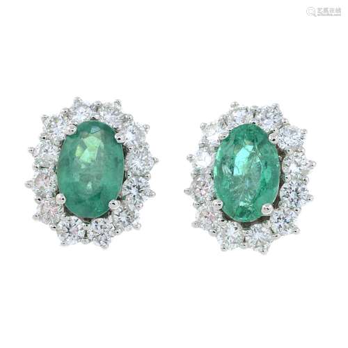 A pair of 18ct gold emerald and diamond cluster stud earring...