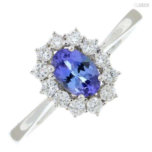 An 18ct gold tanzanite and diamond cluster ring.Tanzanite we...