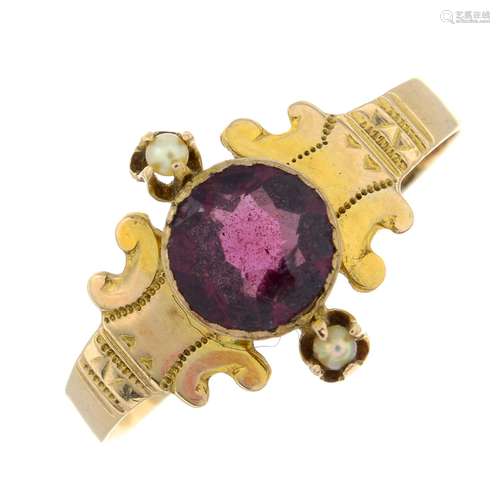 An early 20th century gold garnet and seed pearl dress ring....