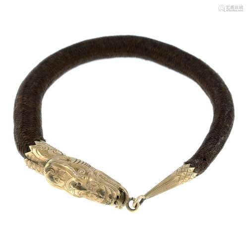 A late Victorian gold woven hairwork memorial bracelet, desi...