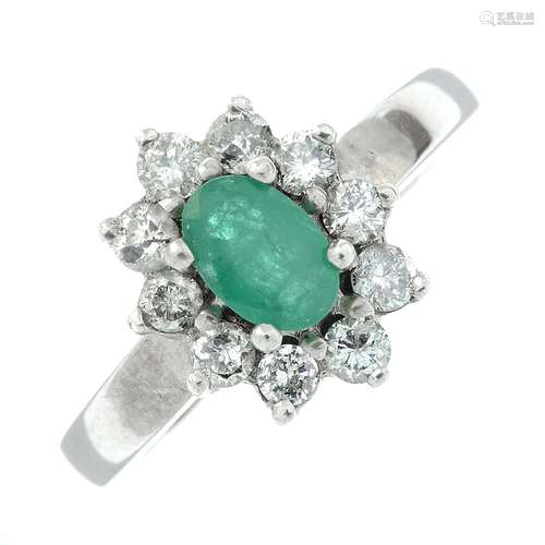 An 18ct gold emerald and brilliant-cut diamond cluster ring....