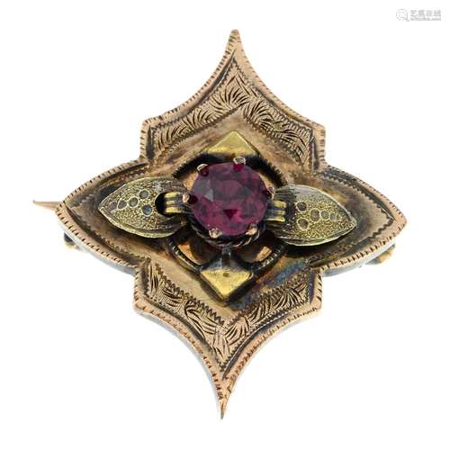 A late 19th century gold garnet floral brooch.Length 2.4cms.