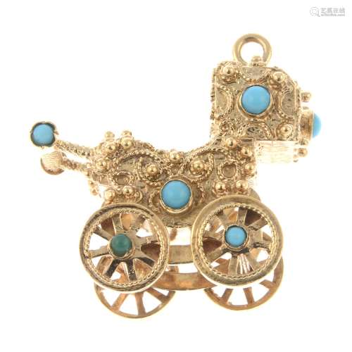 A 9ct gold paste accent pendant, designed to depict a buggy....