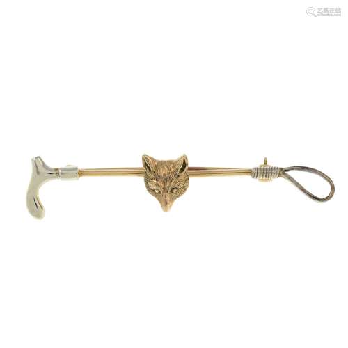 A 9ct gold fox mask and riding crop bar brooch.Hallmarks for...