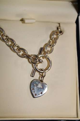 A Royal Mint sapphire & diamond heart shaped pendant with ha...