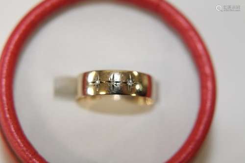 A 9ct gold band ring set with three diamonds