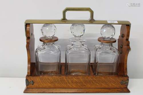 A quality oak & brass three decanter Betjeman tantalus damag...