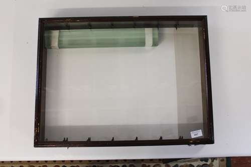 A glazed wooden dealers display cabinet with glass partition...