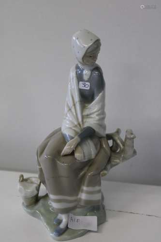 A LLadro figure of a Lady resting on a tree stump A/F h26cm